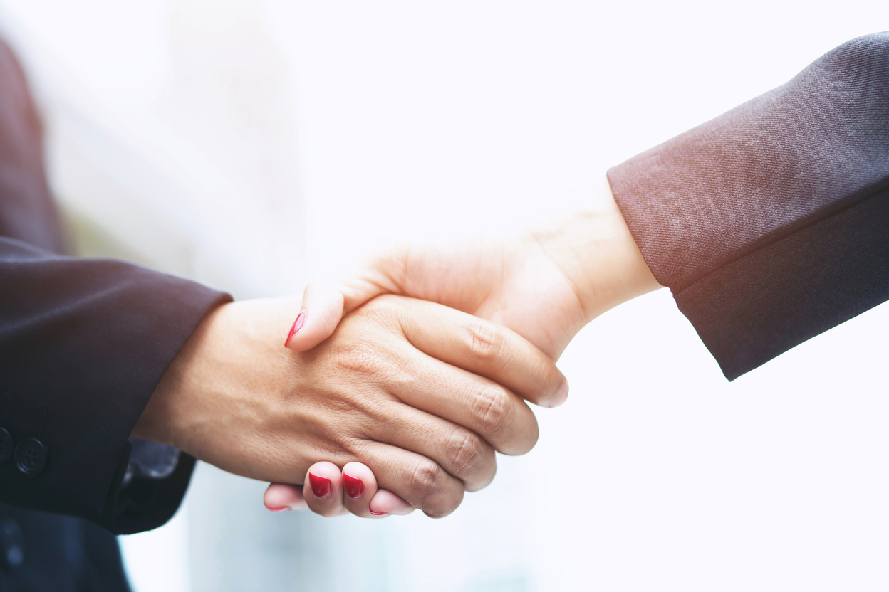 Handshake between Businessman and Businesswoman  